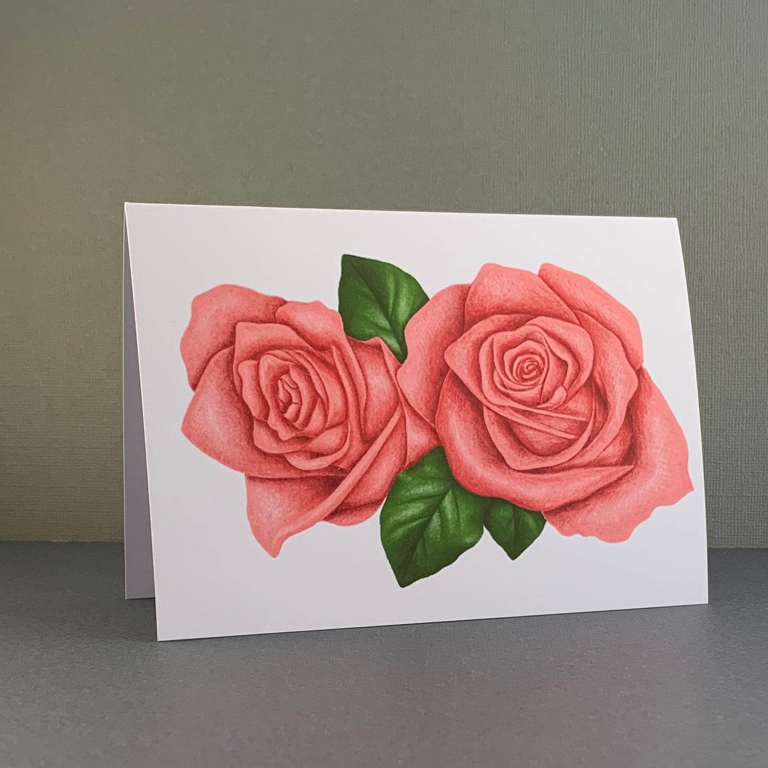 Gratulationskort med illustrerade rosor som motiv.